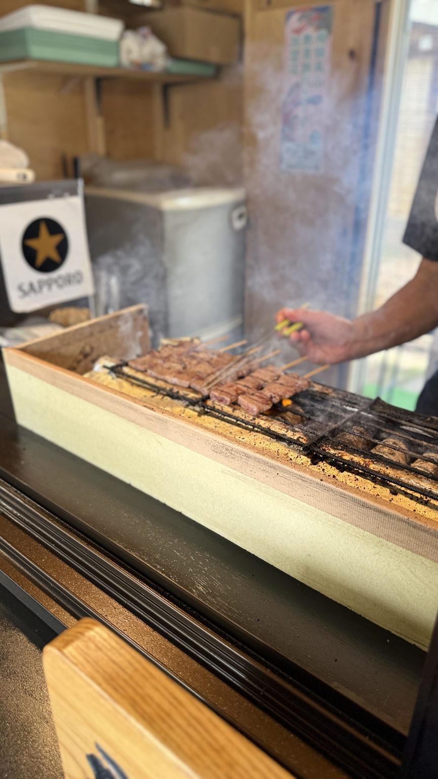 Espetinhos de carne sendo preparados em Takayama